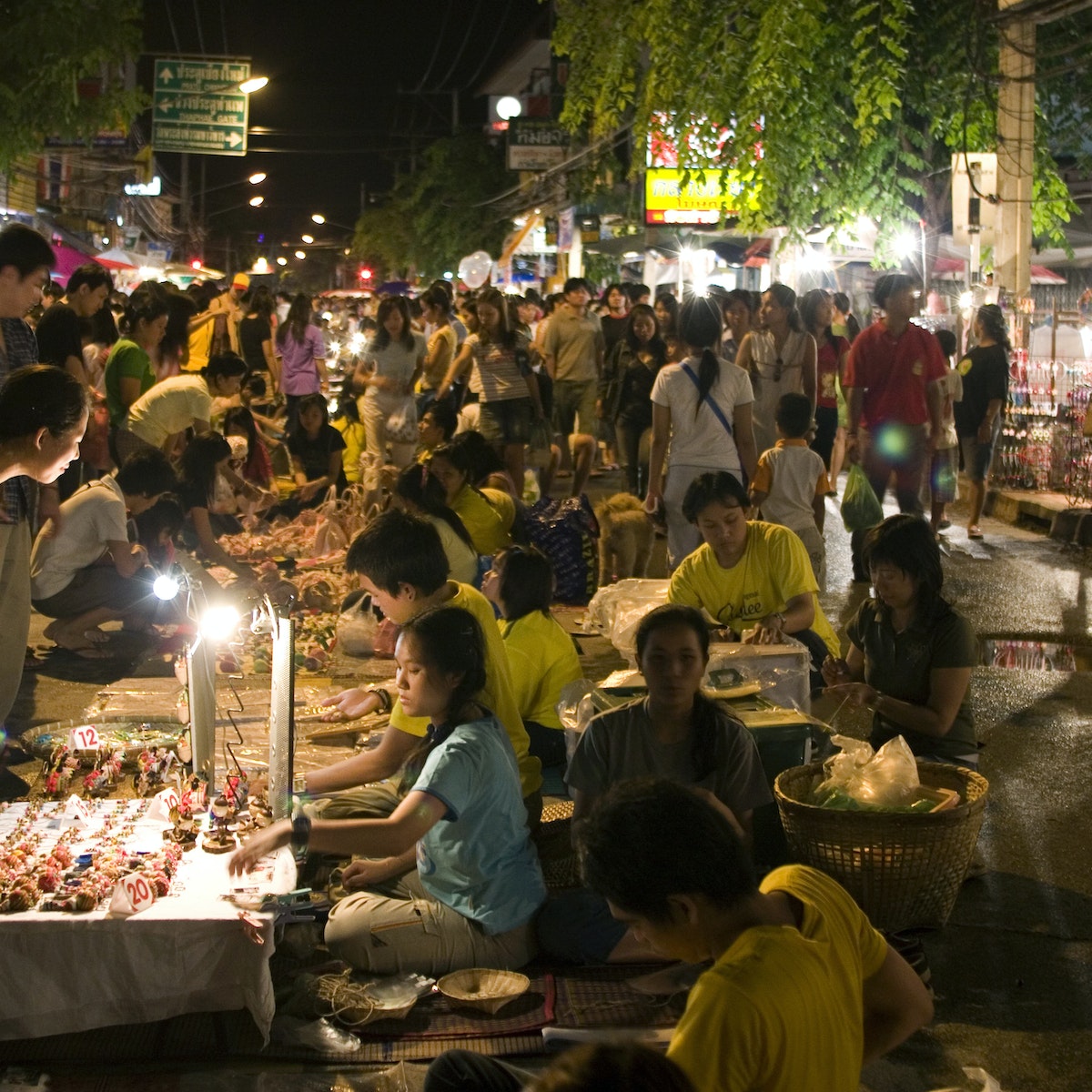 CHIANG MAI, THAILAND - 2006/08/13: The popular walking street market which attracts thousands of locals and tourists each weekend. The market opens in the evening and vendors sell a wide range of goods from traditional produce to pirated DVDs and CDs.. (Photo by Yvan Cohen/LightRocket via Getty Images)