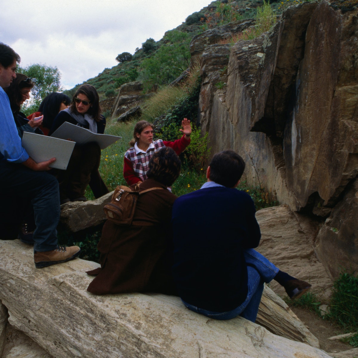 A group visit one of the Paleolithic rock art in the Archeological Park in the Coa Valley, or Parque Arqueologico Vale do Coa, near Vila Nova de Foz Coa. The largest site of such art work found to date the site has been heritage listed.