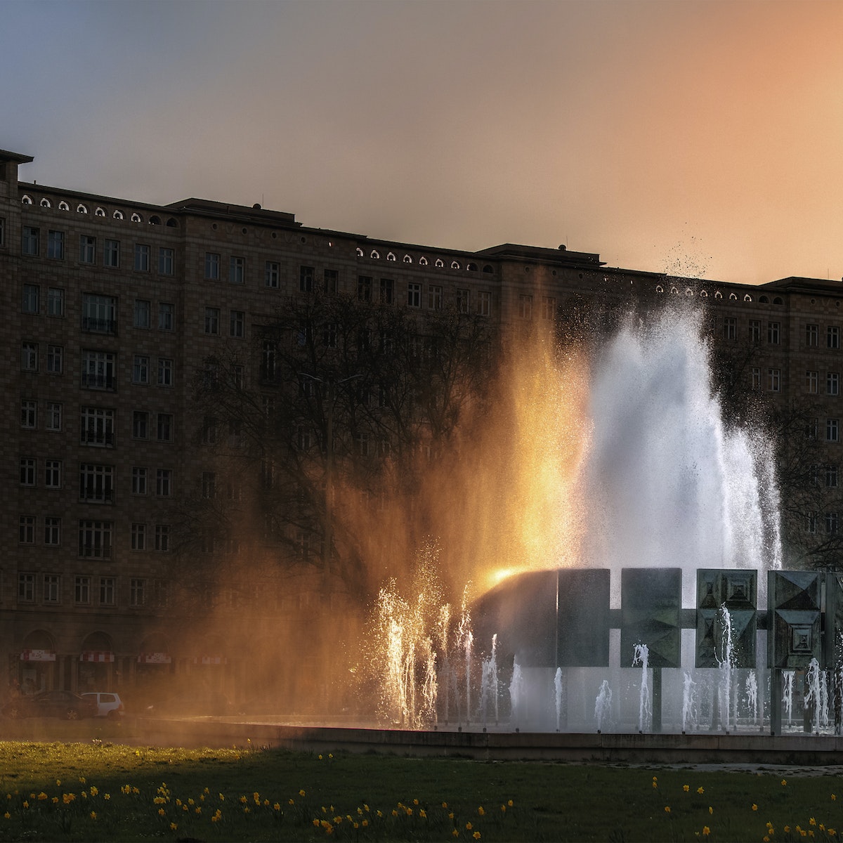 500px Photo ID: 109170205 - The grand fountain in Karl-Marx-Allee, Strausbergerplatz, .The setting sun colours the spray.