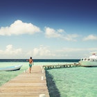 Boy in swimming trunks, walking on jetty on a hot, sunny day
825472850