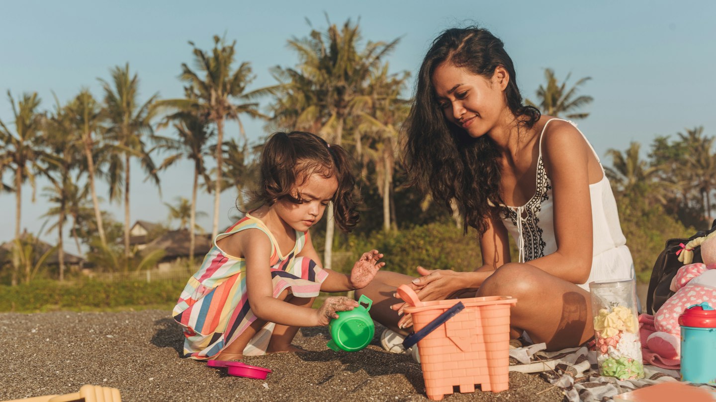 Mother and daughter relaxing on the beach together.
1055292950