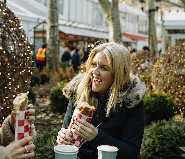 A close-up shot of two mid-adult women sitting down together outdoors to enjoy a sandwich and warm drink in New York City, they are laughing and smiling.
1129579786
new york state, new york city, downtown district, tourism, tourist, travel, travel destinations, journey, friendship, togetherness, 30-34 years, caucasian ethnicity, warm clothing, smiling, happiness, market - retail space, small business, city life, consumerism, customer, food, lifestyles, retail, only mid adult women, take out food, adventure, exploration, arts culture and entertainment, cultures, laughing, street, street food, fast food, outdoors, communication, freedom, cheerful, business finance and industry, adults only, eating, celebration, indulgence, raclette, humor, fun, positive emotion, enjoyment, relaxation, reunion - social gathering, Two People