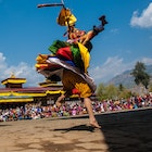 A person in traditional dress dancing at the Paro Tsechu festival, Bhutan