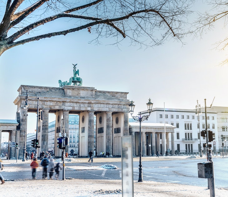 view on winterly Berlin Brandenburger Tor in morning sun
638326526
Capital Cities, Tourism, Paris Platz, Quadriga Statue - Brandenburg Gate, Color Image, Walking, History, Cultures, Famous Place, Architecture, Travel Destinations, Outdoors, Horizontal, Tourist, People, Brandenburg Gate, Berlin, Germany, Europe, Tree, Sunlight, Day, Winter, Sun, Snow, Sign, Symbol, blue sky, Sunny