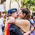 Annual gay pride march held in the streets of the city of Buenos Aires in November 2017. Young couple of two lesbian women hugged wanting to kiss each other in the middle of the crowd.