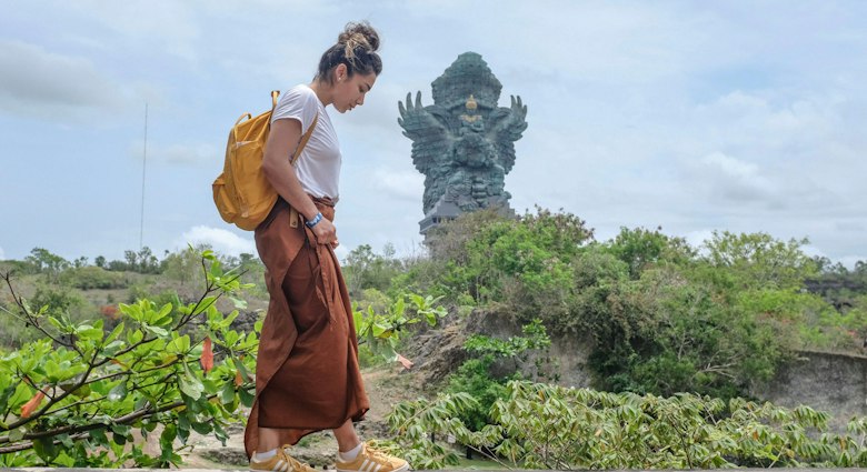 Tourist woman is visiting Garuda Wisnu Kencana Cultural Park or GWK. Vacation, tourism, balinese, Indonesian tourism, landmarks tourism in Bali.Traveling solo concept. Indonesia, Bali. 28/11/2018