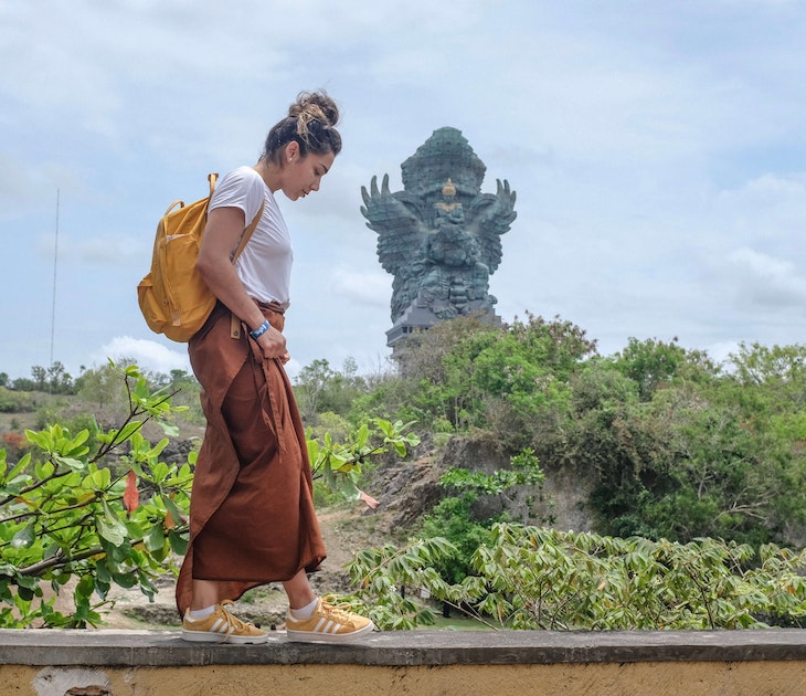 Tourist woman is visiting Garuda Wisnu Kencana Cultural Park or GWK. Vacation, tourism, balinese, Indonesian tourism, landmarks tourism in Bali.Traveling solo concept. Indonesia, Bali. 28/11/2018