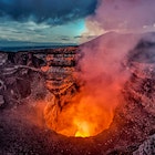 Volcano crater eruption with flowing lava and smoke.  The Masaya Volcano near Managua, Nicaragua main crater after sunset.; Shutterstock ID 1071081989; your: -; gl: -; netsuite: -; full: -