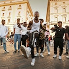 Unidentified B-boy break dancers perform in the street for the crowd. Hip Hop battle at an informal street dance meet.