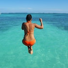 BELIZE - NOVEMBER 2016: A woman jumps off a dock and into the Caribbean Sea in San Pedro, Belize. ; Shutterstock ID 517065442; full: 65050; gl: Online Editorial; netsuite: Things to know Belize; your: Bailey Freeman
517065442