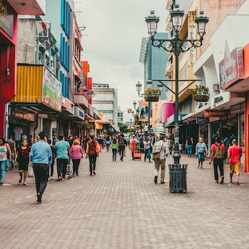 Pedestrians walking in a busy San Jose shopping district.
