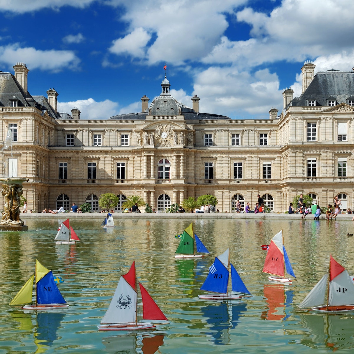 JULY 30, 2012: Model sailing boats in the pool in front of Luxembourg Palace in Luxembourg Gardens.