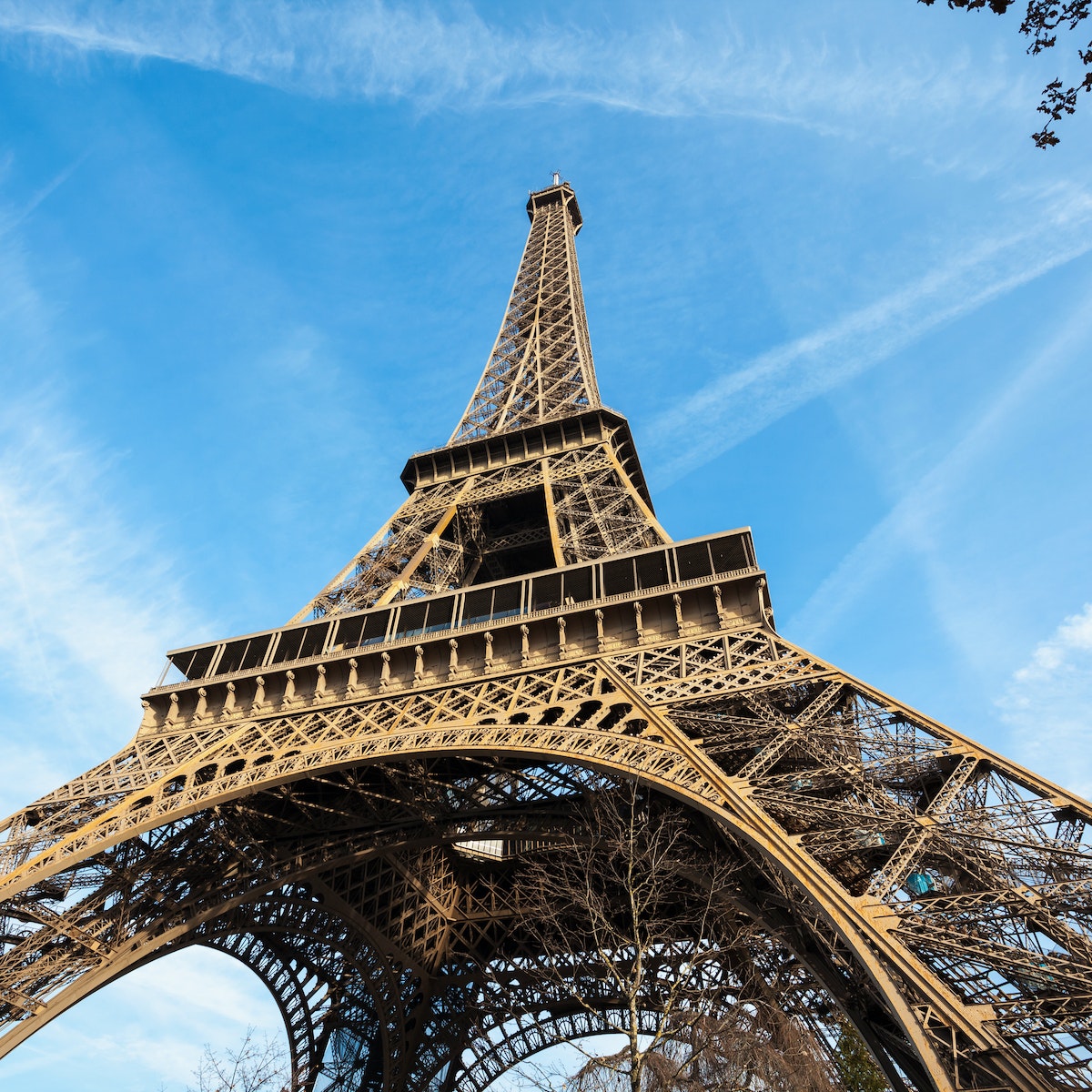 Wide shot of Eiffel Tower with blue sky, Paris, France.