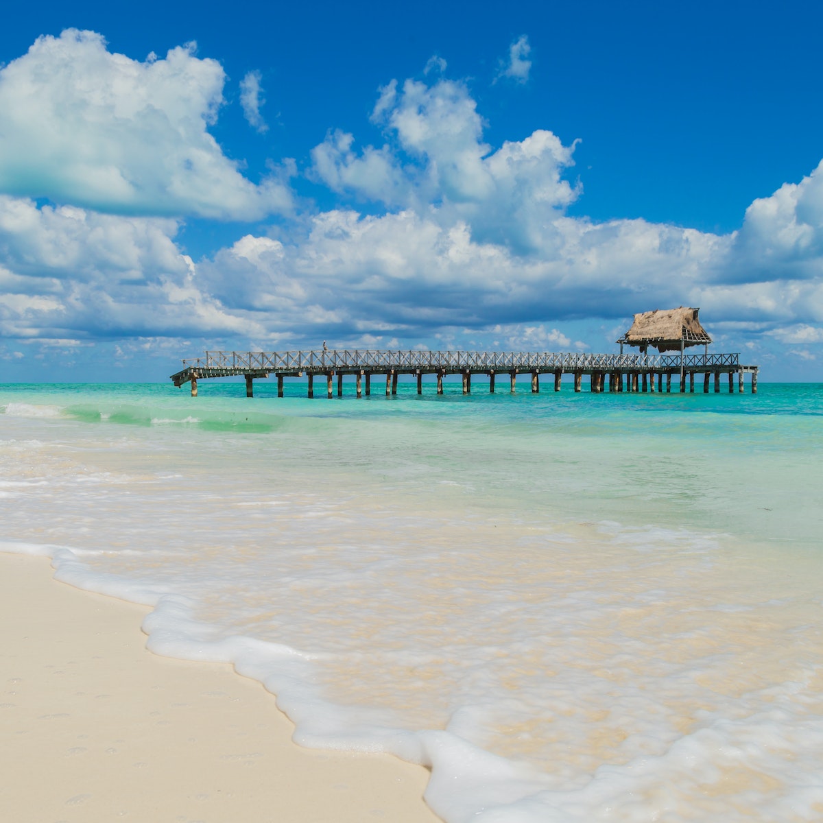 Destroyed jetty on a white sandy beach at Isla Blanca.