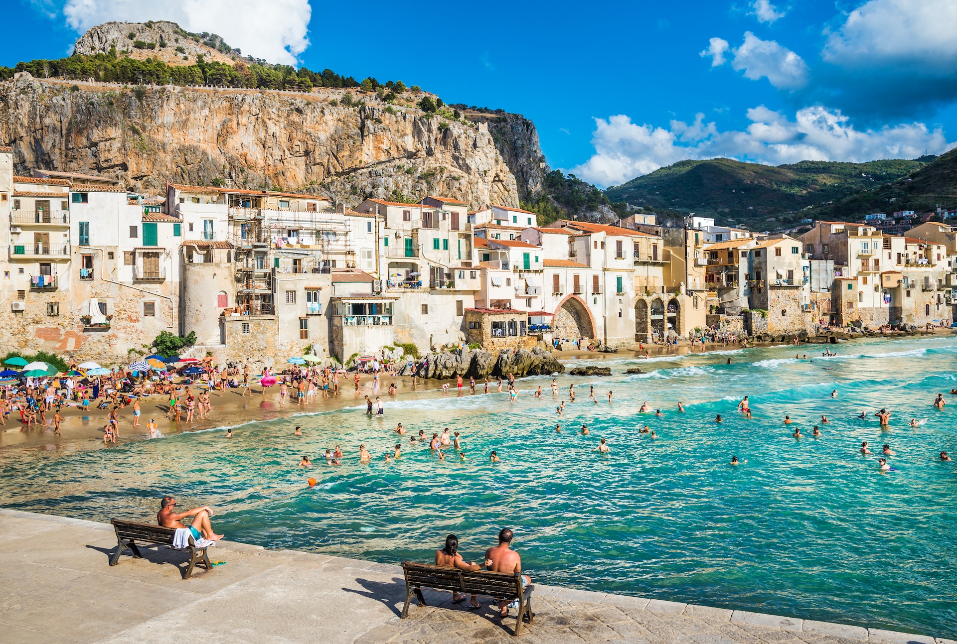 Visitors crowd the beach at Cefalu on a sunny day