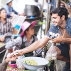 Unidentified foreigner buying Thai desserts from sailor who making food on a boat at Amphora, Thailand.
1286459085